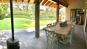 Terraza techada con comedor con vista al jardín 